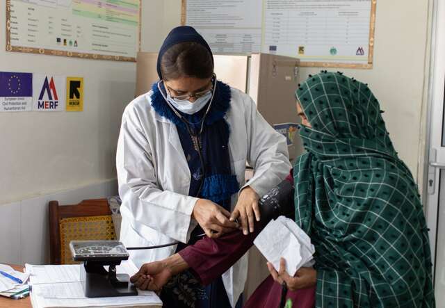 A woman receiving a vaccination from a doctor
