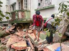 Man walking through rubble after earthquake strikes Myanmar